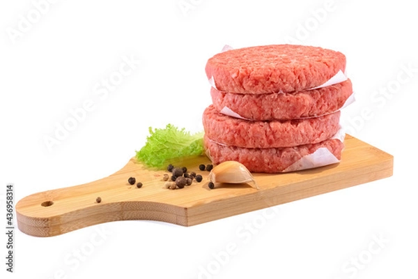Fototapeta Raw beef patties for making a burger.Isolated on a white background.Selective Focus.