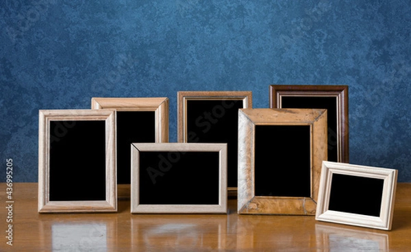 Fototapeta frames on table, blue wall