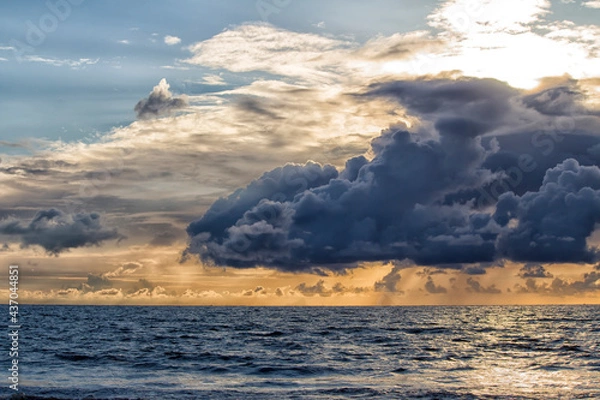 Fototapeta Pre-monsoon clouds during evening over a beach