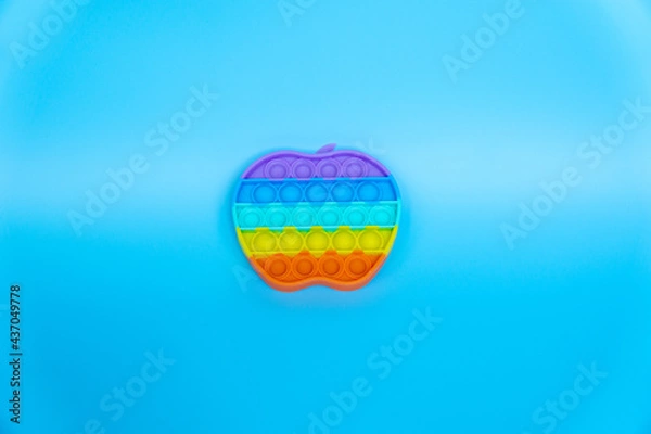 Obraz colorful silicon antistress sensory toy fidget push pop it on blue background