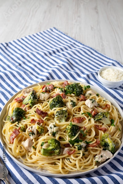 Fototapeta Homemade Chicken Bacon Broccoli Alfredo on a plate, side view. Space for text.