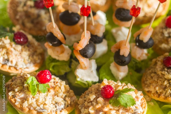 Fototapeta snacks on the festive table on skewers and in tartlets