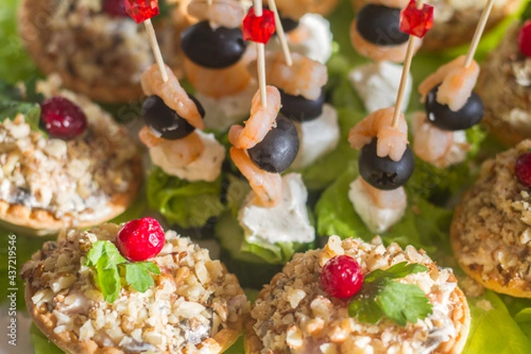 Fototapeta snacks on the festive table on skewers and in tartlets