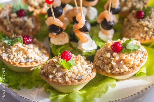 Fototapeta snacks on the festive table on skewers and in tartlets