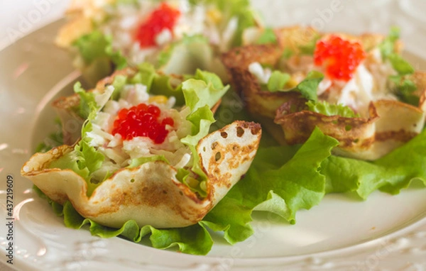 Fototapeta festive baskets tartlets made of pancakes with stuffing and decorated with red caviar