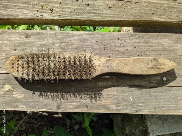 Obraz old wire brush on wooden background top view