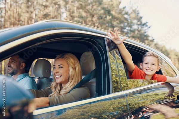 Obraz Young beautiful family with little boy having fun and smiling while driving in the car