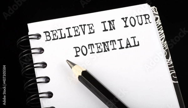Fototapeta Believe In Your Potential written text in small notebook on a black background
