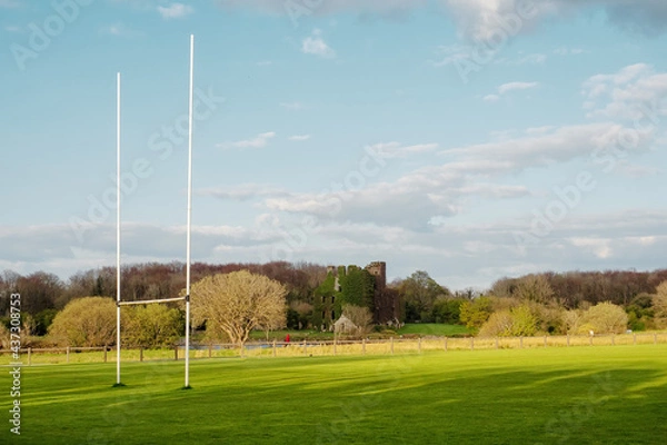 Obraz Tall goal posts for Irish national sports, camogie, hurling, Gaelic football, soccer and rugby. Warm sunny day. Blue cloudy sky. Menlo castle in the background. Galway city, Ireland
