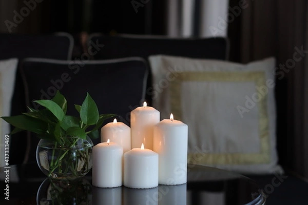 Fototapeta candles group of white candles arranged in a level in the living room
