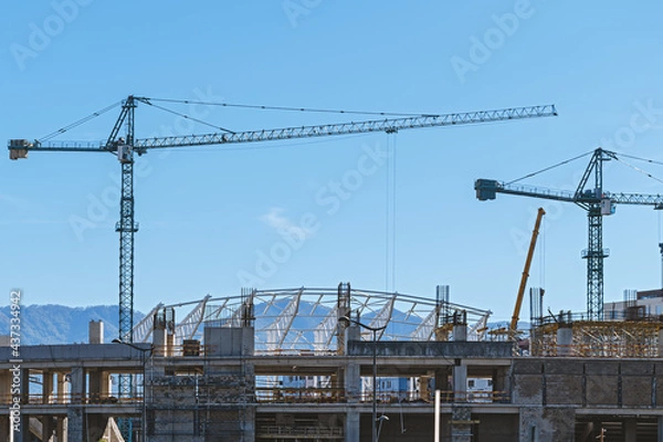 Fototapeta Construction site with tower cranes.