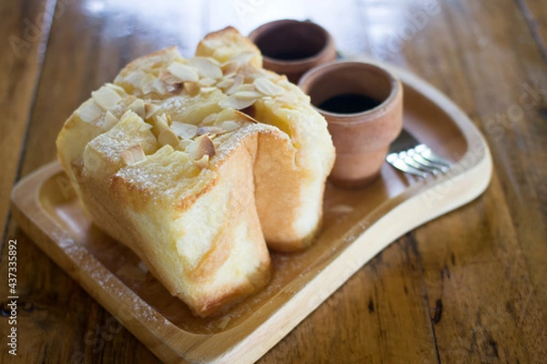 Fototapeta Honey toast topping by almond slice and chocolate syrup, selective focus