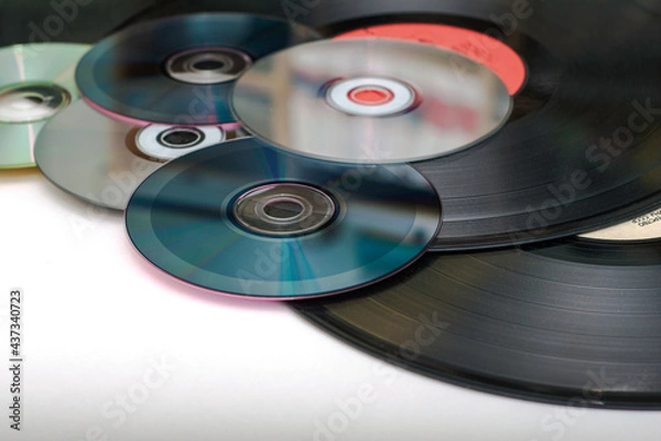 Obraz vinyl discs and CDs on a white surface concept storage of information progress