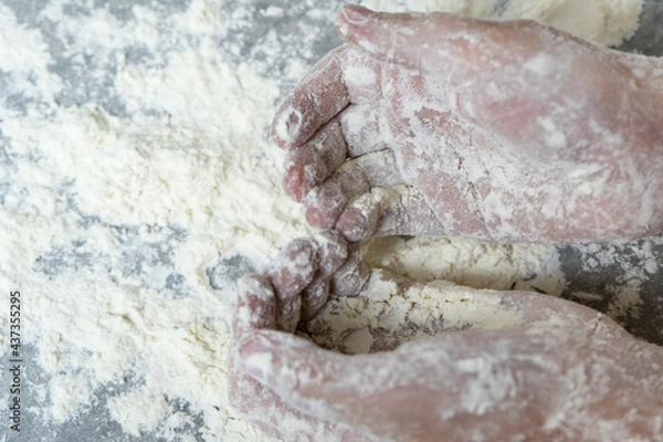 Obraz Hands in flour. Homemade cake. Cooking in the kitchen.