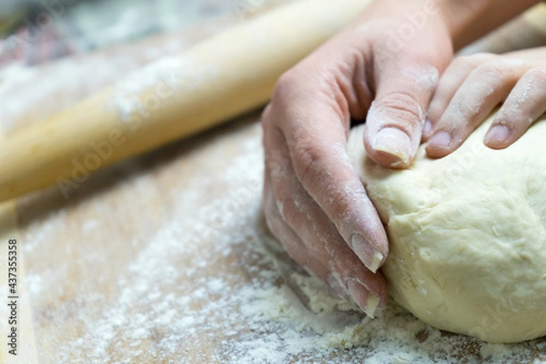 Obraz Manual kneading of dough for cooking homemade food.