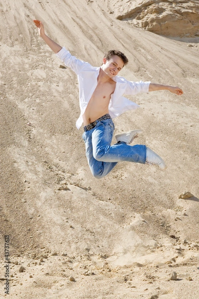 Obraz Young man jumping in the sand