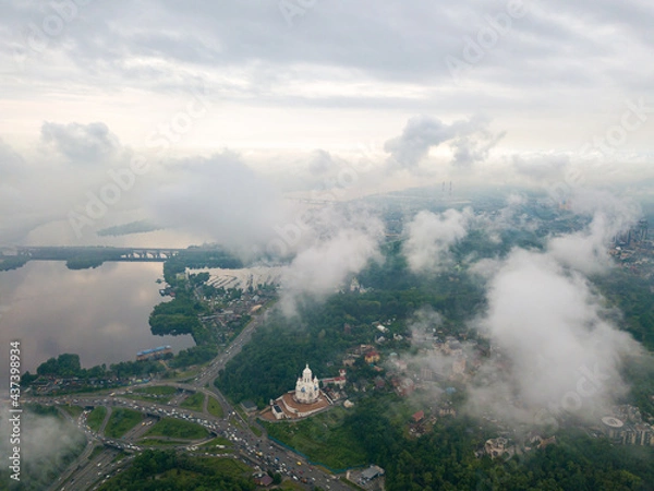 Fototapeta High view of the Dnieper River in Kiev through the clouds. Spring cloudy morning. Aerial high view.