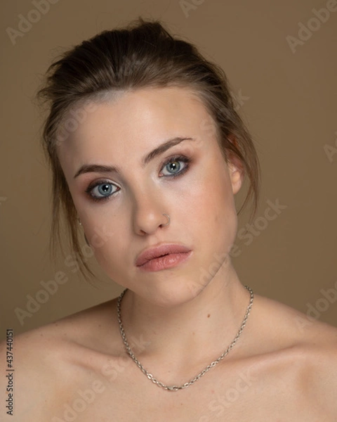 Fototapeta a emphatic girl with eyes of different colors looks forward, she has an interesting short hairstyle, expressive cheekbones, gorgeous lips