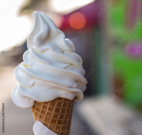 Fototapeta soft serve vanilla ice cream cone stock photo with a boardwalk background outside street 
