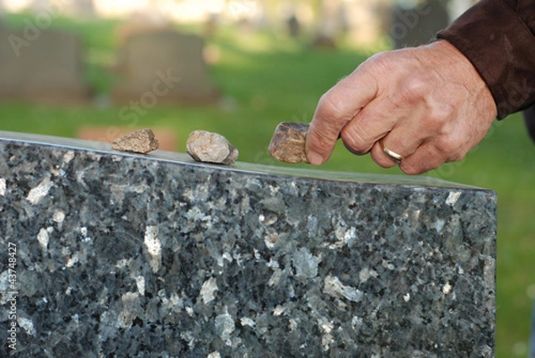 Obraz Placing stone on tombstone