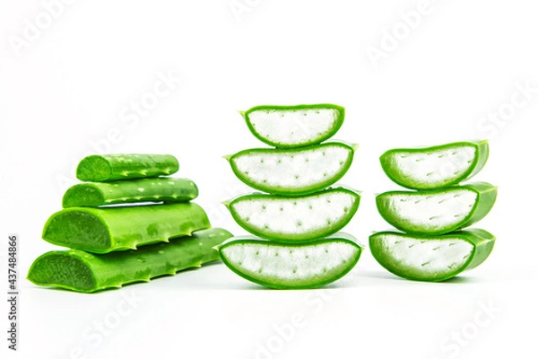 Fototapeta Aloe vera, Close-up slices of green fresh aloe vera plant stacked and aloe vera stalk or leaves with water dropping isolate on white background.