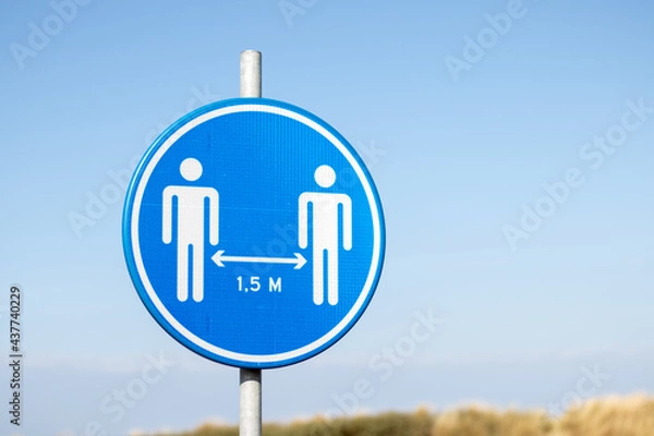 Fototapeta Social distancing sign at the beach asking to keep 1.5 meters distance due to the corona virus