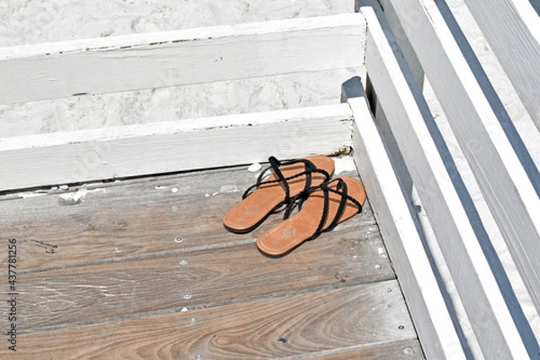 Obraz Sandals on a Deck Overlooking the Beach