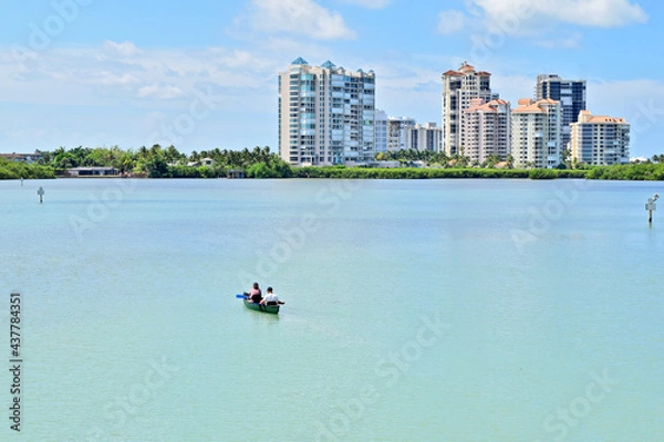 Fototapeta Kayaking in a Lake with Condominums in the Background