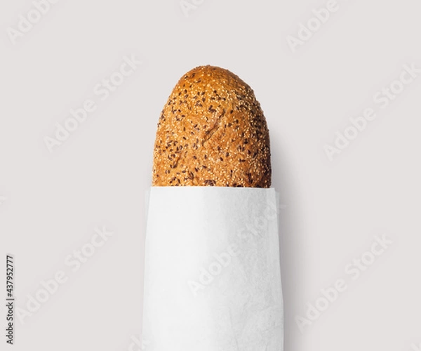Obraz Fresh bread baked with seeds in a kraft paper bag, natural, white or black!