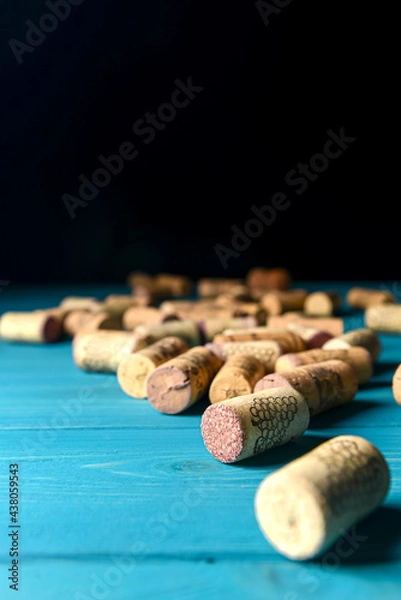 Fototapeta Collection set of wine corks over pastel blue rustic wooden background. Art concept, creative idea. Spring table