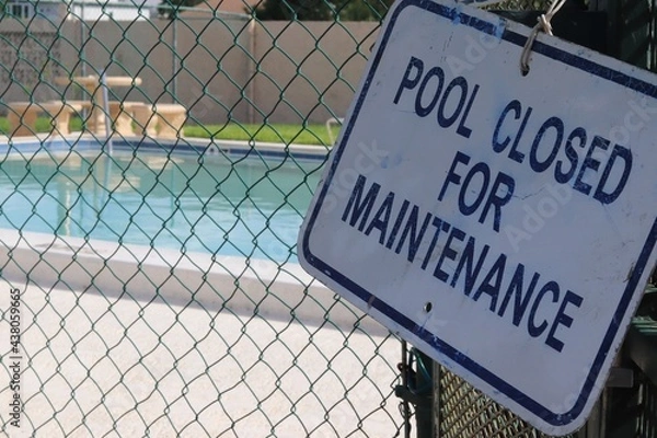 Fototapeta 'Pool Closed for Maintenance' Sign with Pool in Background