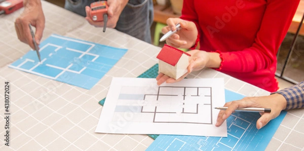 Fototapeta Engineer and Architect planing and discuss at Construction Site with blueprint