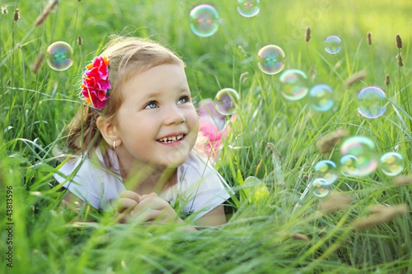 Obraz Happy little girl playing with bubbles