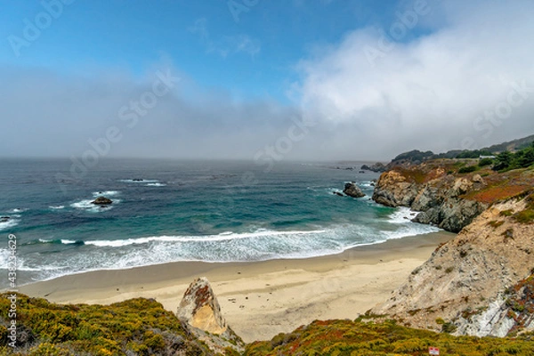 Fototapeta Beach Pacific Ocean Rocks with fog clouds misting and blue sky