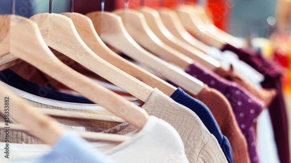 Fototapeta Summer cotton handmade dresses hang on a hanger in the store.