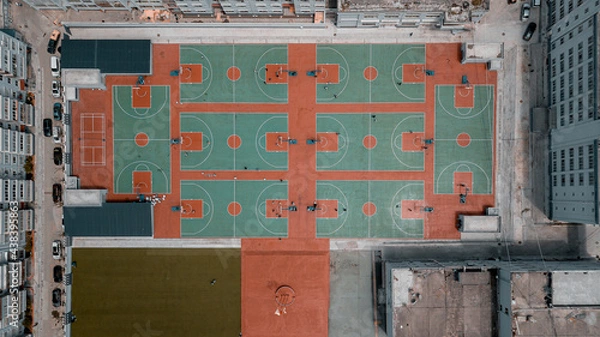 Obraz Top down aerial view of residential area, school, university with many basketball courts between buildings. Geometry lines in architecture, modern city development care about sports and healthy people