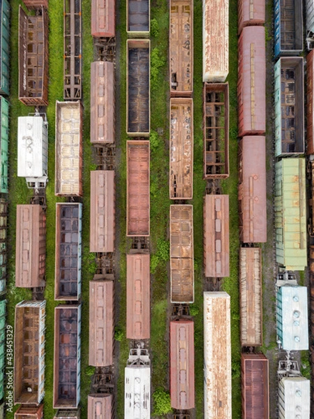 Fototapeta Freight trains on railway tracks. Aerial drone top view. Sunny spring day.