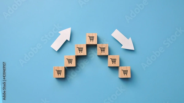 Fototapeta Wooden cubes in the form of a pyramid and up and down arrows. A symbol of growth and decline in business performance