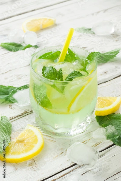 Obraz Mojito cocktail with lime and mint. Vertical photo.