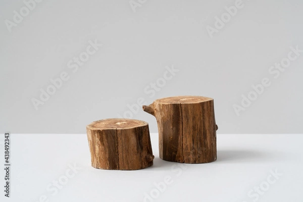 Fototapeta Two empty round wooden podium for product presentation on grey background. Natural materials mockup for cosmetic advertising. Eco concept. Copy space, front view. 