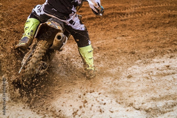 Fototapeta Close up of motocross racer accelerating in dirt track