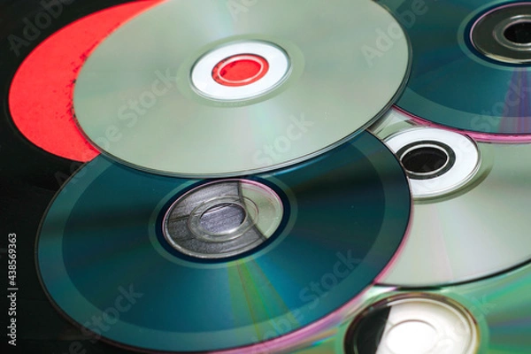 Obraz vinyl discs and CDs on a white surface concept storage of information progress