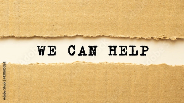 Fototapeta Text WE CAN HELP appearing behind torn brown paper. Top view.