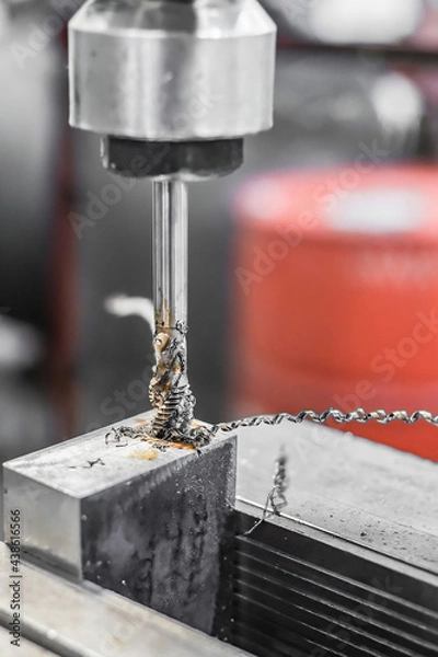 Fototapeta A tap on a machine for tapping a hole in a part.