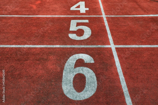 Fototapeta The red plastic track is on the playground