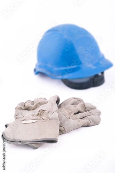 Obraz Blue working helmet and working gloves, white background.