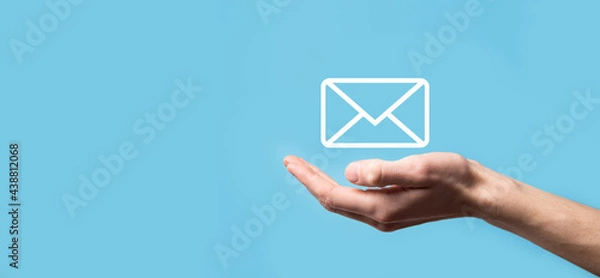 Fototapeta Male hand holding letter icon,email icons .Contact us by newsletter email and protect your personal information from spam mail. Customer service call center contact us.Email marketing and newsletter