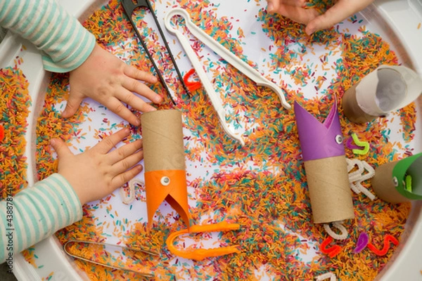 Obraz DIY children game. activities at home. Feed a bird. Sorting game with colored rice. Sensory therapy, fine motoric skills, early education