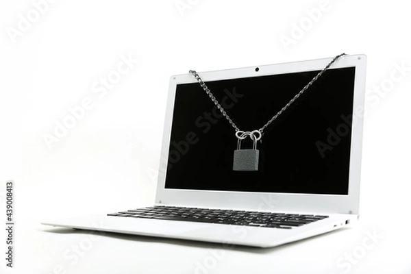 Obraz computer with chain and padlock on a white background. concept of limiting access to a computer. internet security concept. the concept of limiting children's access to the computer 