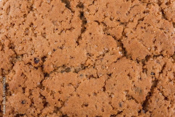 Fototapeta Texture background of oat cookie with sugar and raisins.